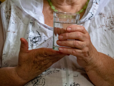 elderly-woman-with-beautiful-wrinkled-face-is-hold-2025-10-15-20-55-51-utc